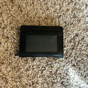 Never used black wallet with inside pockets and zipper